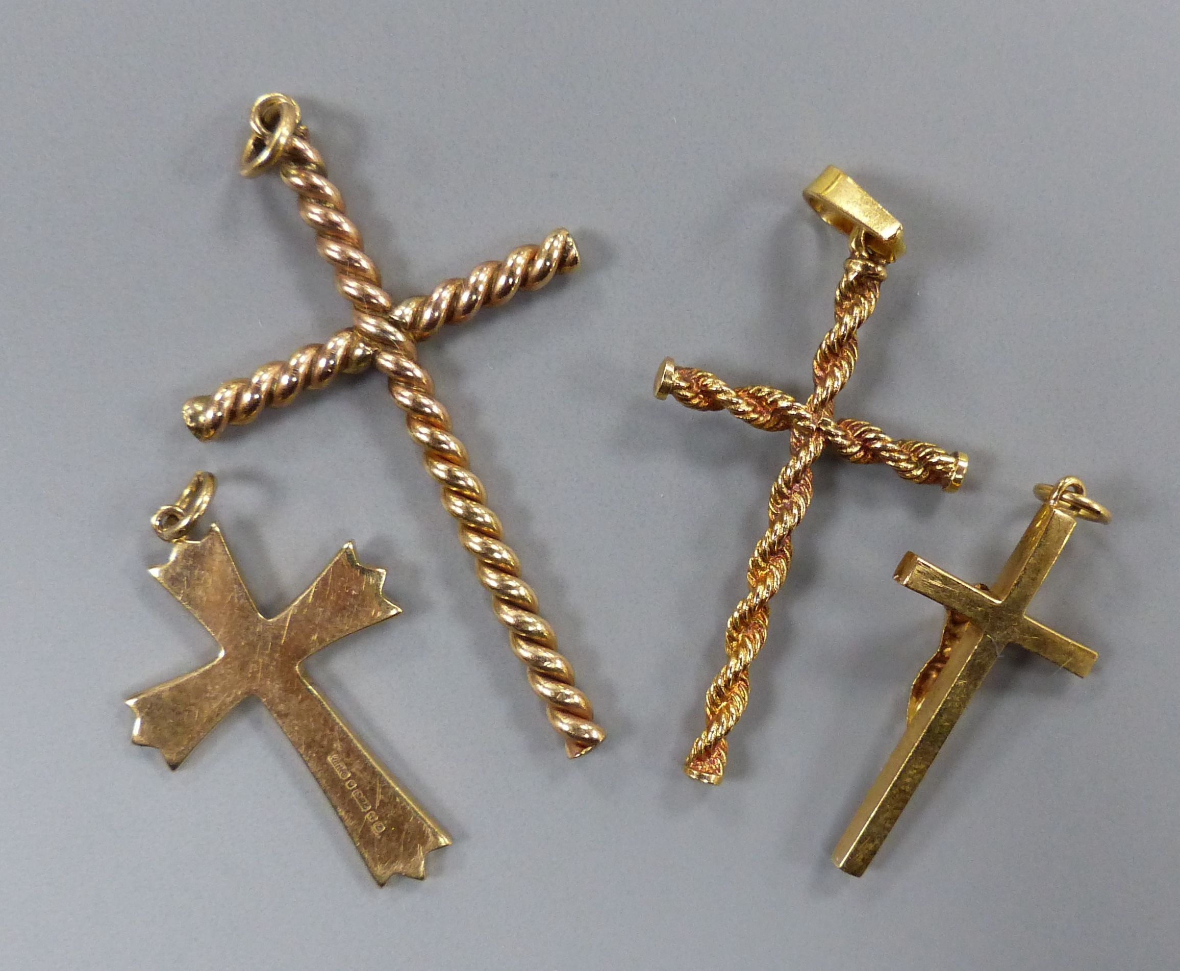 Four assorted modern 9ct gold cross pendants, largest 43mm,